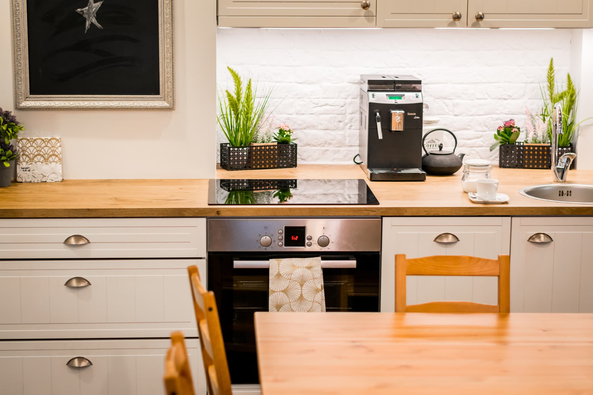 Frontal detail of the event studio kitchen cabinetry, timber worktop and dining table