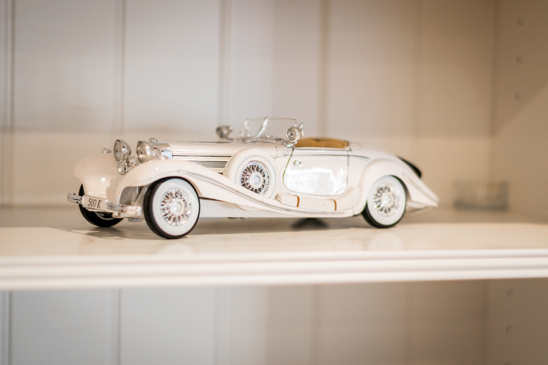 Decorative model car displayed within the event studio shelving