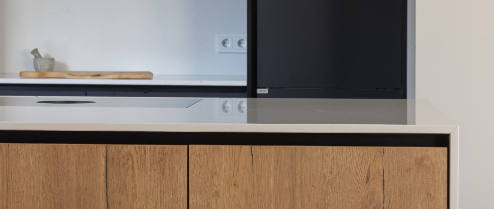 Custom kitchen in dark oak and pale stone