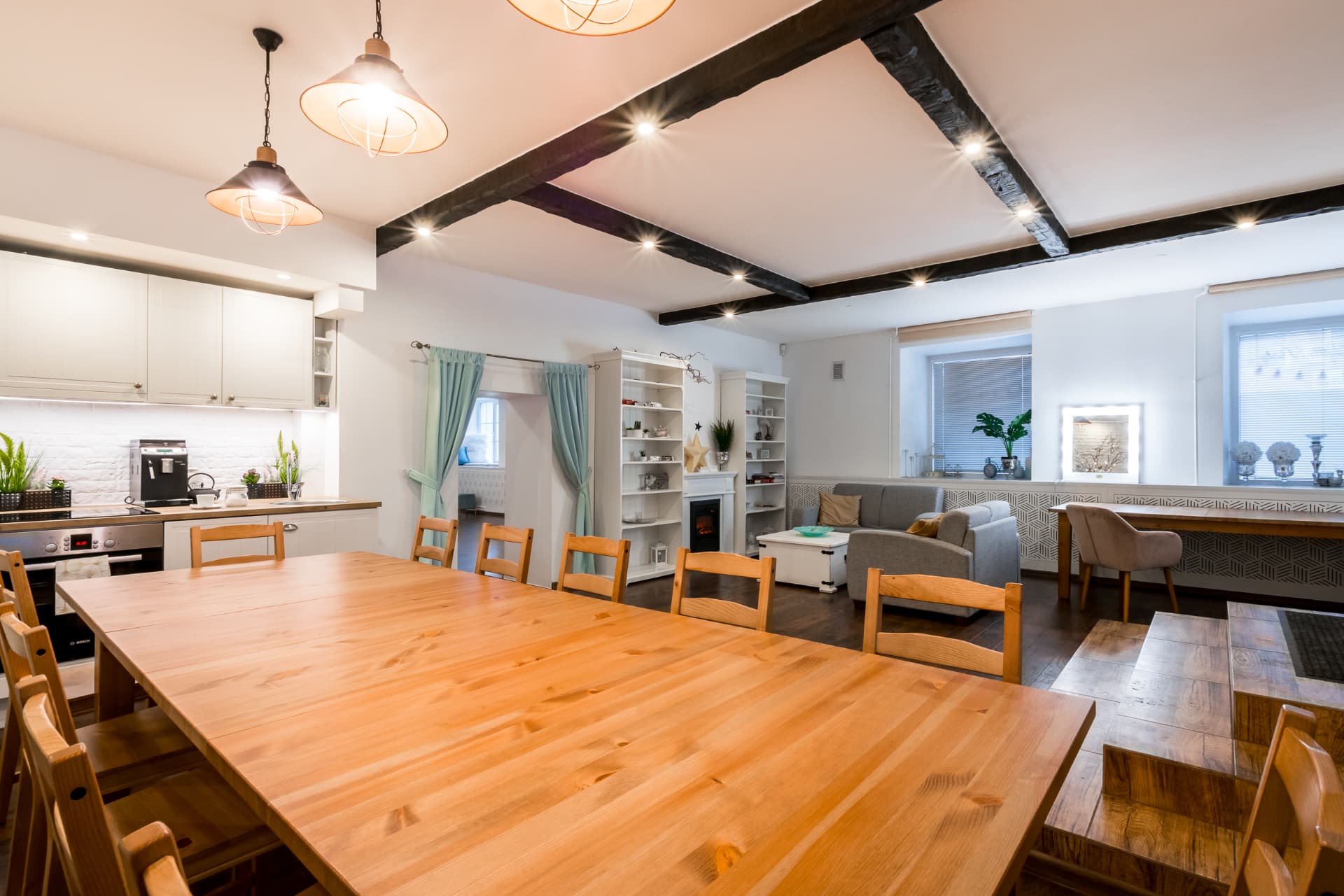 Wide view across the event studio showing the dining, kitchen and lounge areas